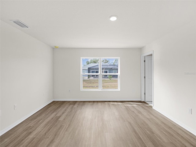 spare room featuring light hardwood / wood-style floors