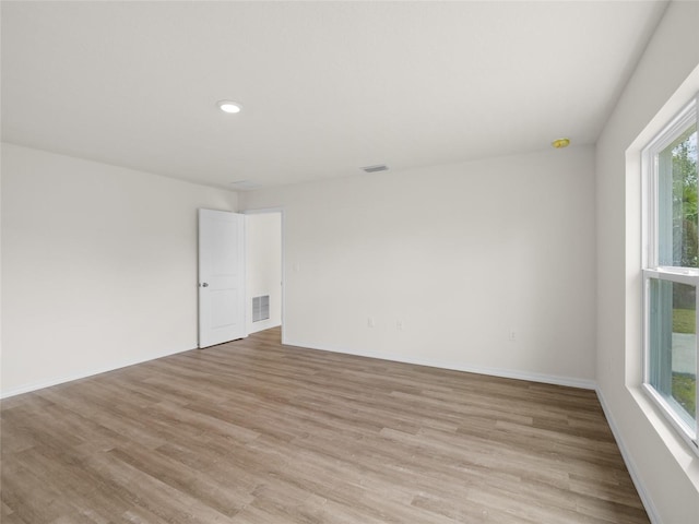 unfurnished room with light hardwood / wood-style flooring