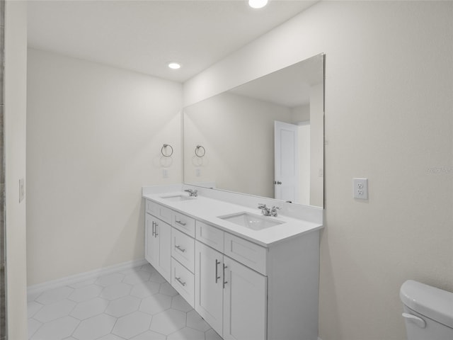 bathroom with tile patterned floors, vanity, and toilet