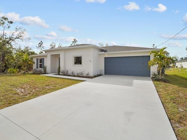 view of front of home with a front yard and a garage