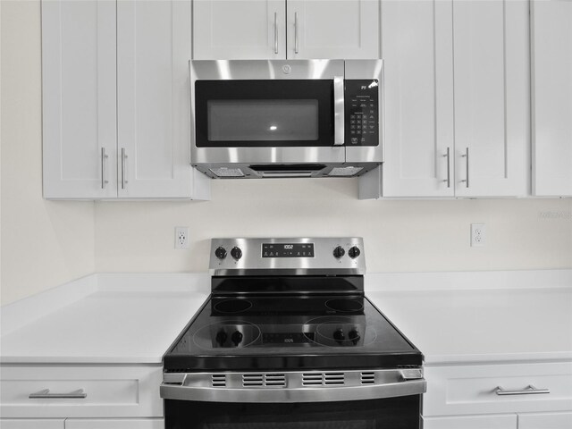 kitchen featuring white cabinets and appliances with stainless steel finishes