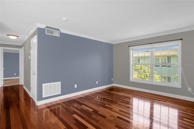 empty room featuring crown molding and dark hardwood / wood-style flooring