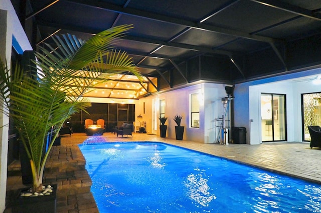 view of swimming pool with a lanai and a patio area