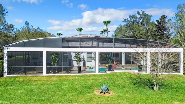 rear view of property with glass enclosure, an outdoor pool, a patio area, and a yard