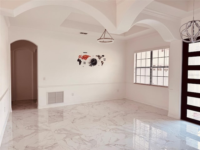 unfurnished room featuring crown molding, a raised ceiling, and a notable chandelier