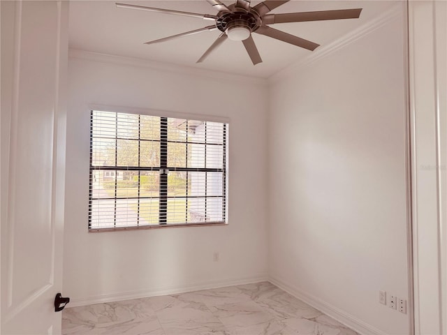 empty room with marble finish floor, baseboards, and crown molding