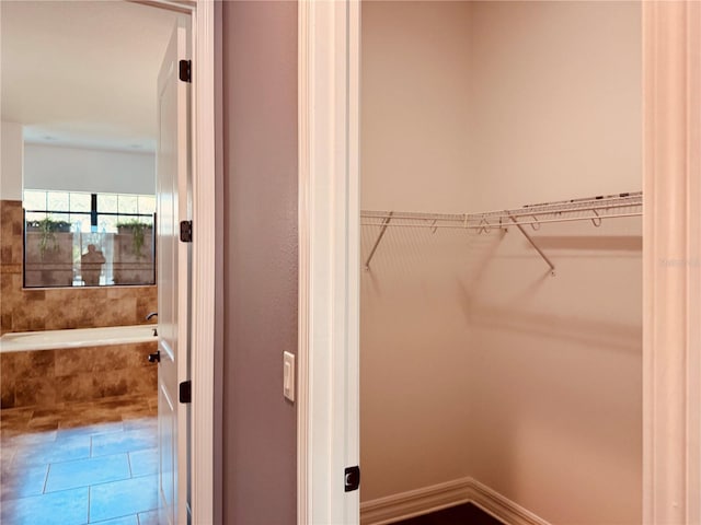 walk in closet featuring tile patterned flooring