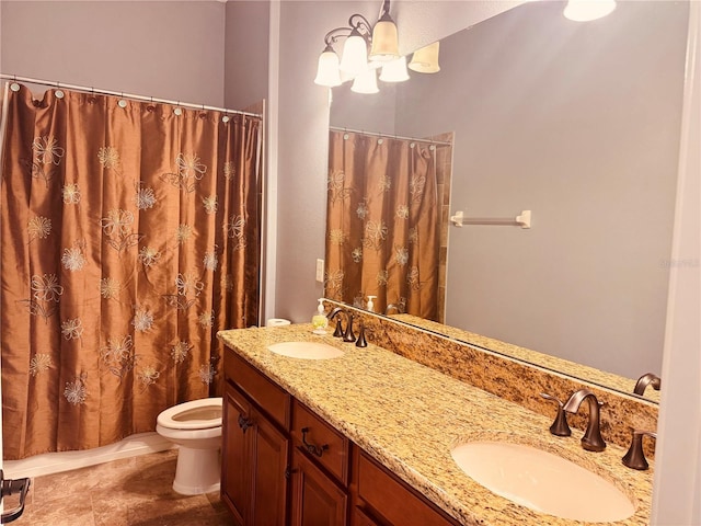 bathroom with toilet, an inviting chandelier, and vanity