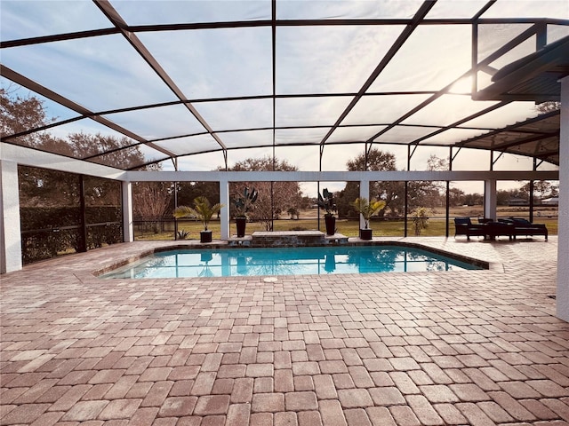 view of swimming pool with a lanai and a patio area