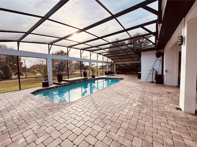 pool featuring glass enclosure and a patio