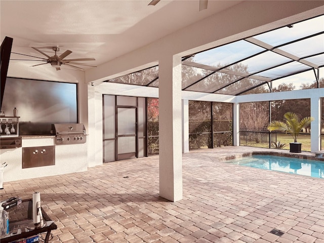 outdoor pool with ceiling fan and area for grilling