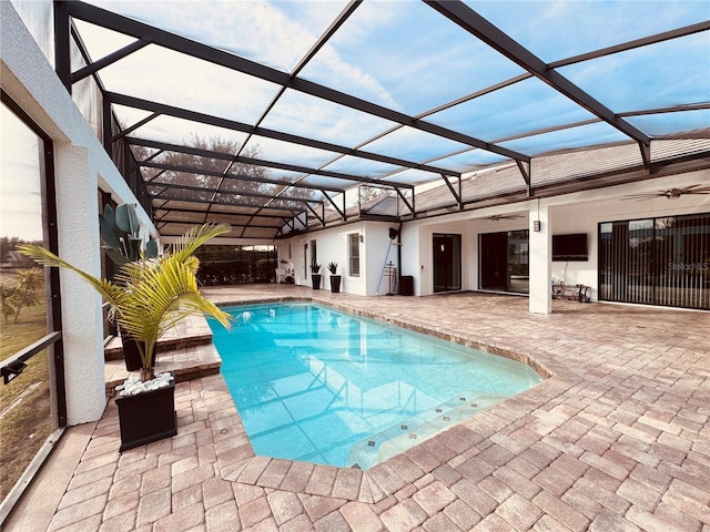 view of pool featuring a patio area, a lanai, and ceiling fan