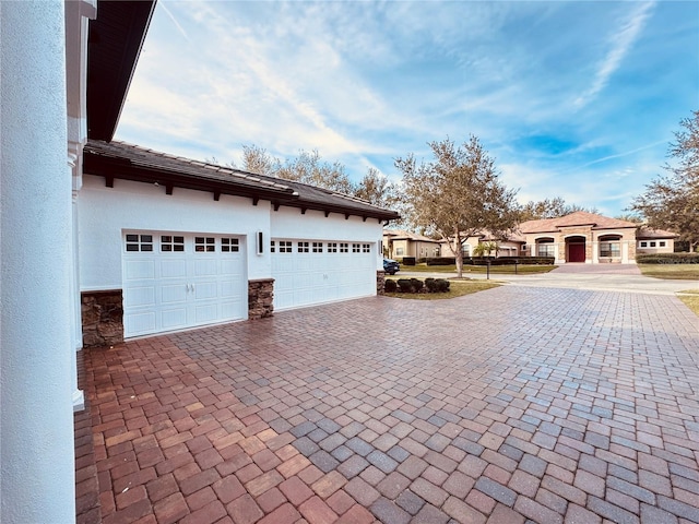 exterior space featuring decorative driveway