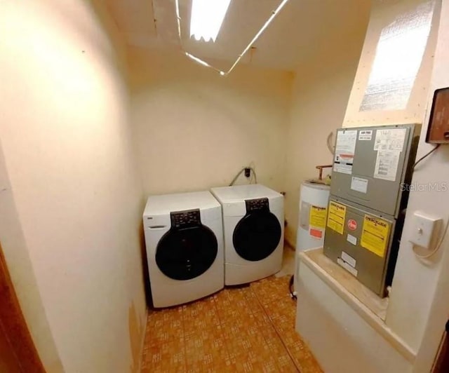 laundry room with separate washer and dryer, heating utilities, light tile floors, and water heater