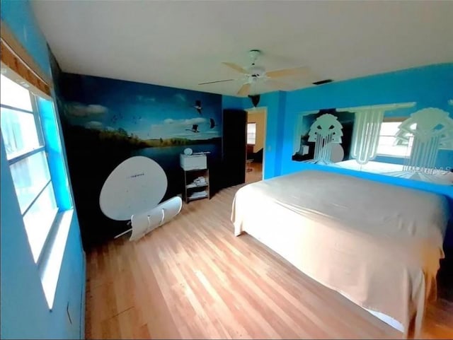 bedroom with ceiling fan and light hardwood / wood-style flooring