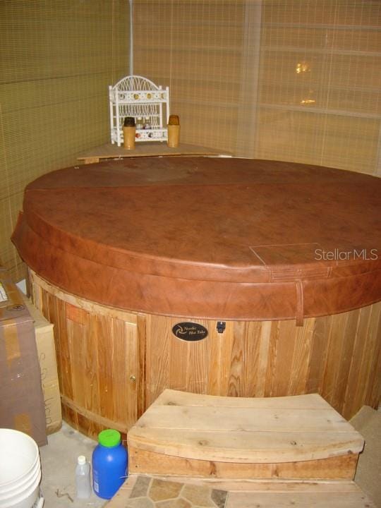 interior space featuring toilet and wood walls