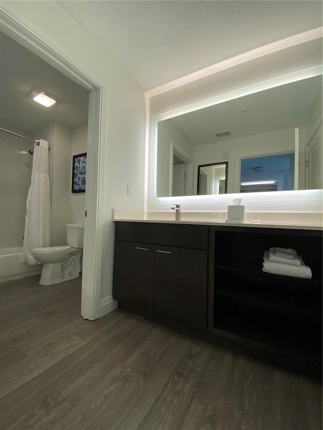 full bathroom featuring shower / tub combo, toilet, vanity, and wood-type flooring