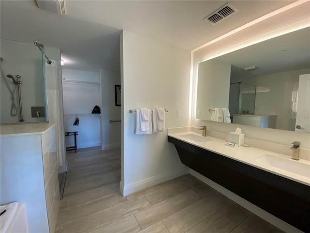 bathroom featuring dual vanity and hardwood / wood-style flooring