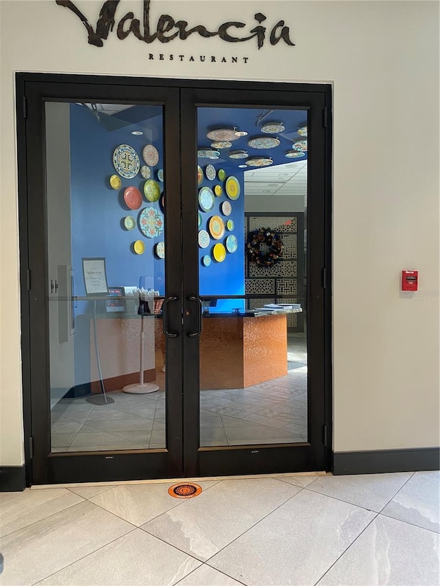 doorway with light tile floors and french doors