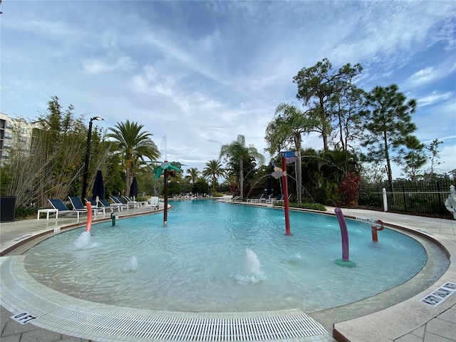 view of swimming pool with pool water feature