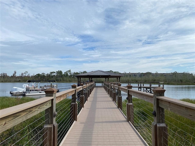 view of dock with a gazebo and a water view