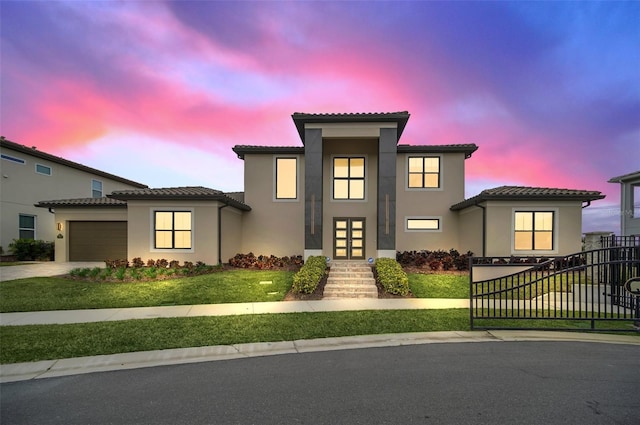 view of front of home featuring a lawn and a garage