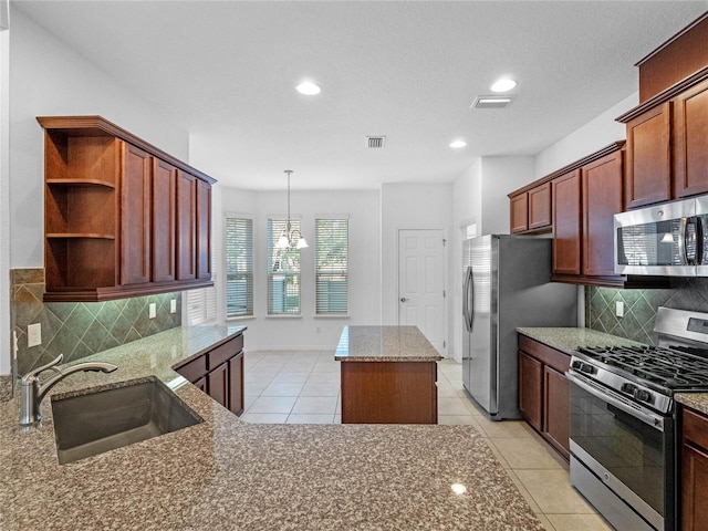 kitchen featuring tasteful backsplash, stainless steel appliances, sink, light tile patterned floors, and a chandelier