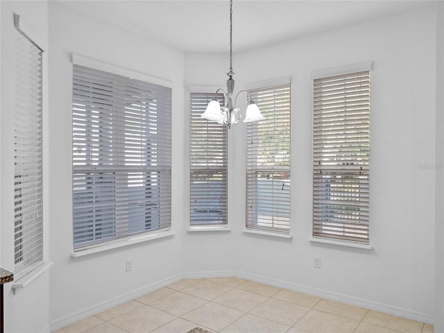 unfurnished dining area featuring a chandelier and light tile patterned floors