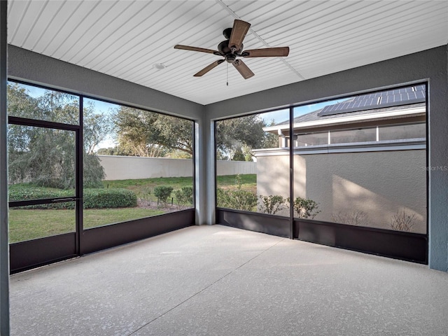 unfurnished sunroom with ceiling fan and a healthy amount of sunlight