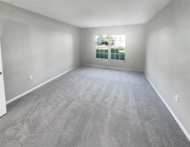 spare room featuring light colored carpet