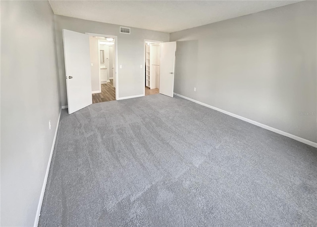 unfurnished bedroom featuring dark colored carpet