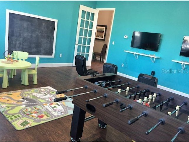 playroom with dark hardwood / wood-style floors