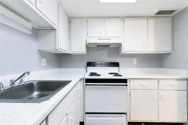 kitchen with white cabinets, white electric range, and sink