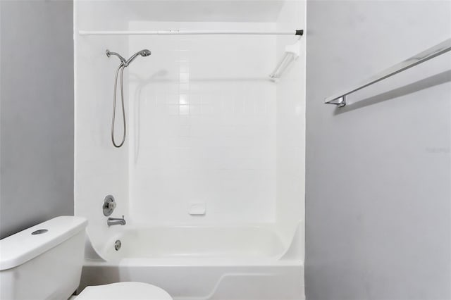 bathroom with toilet and bathtub / shower combination