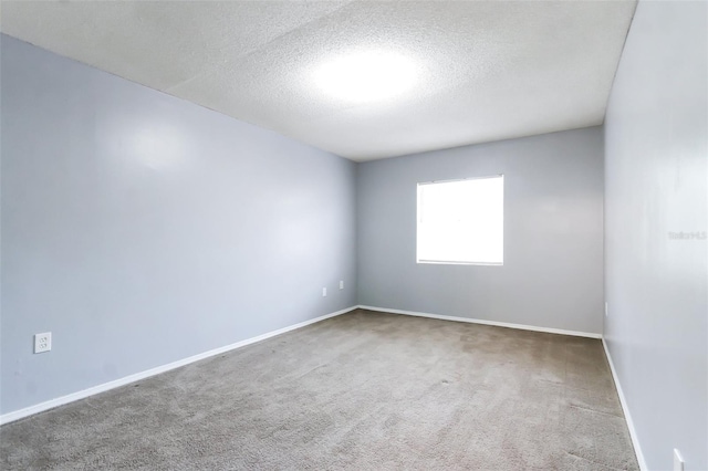 empty room featuring carpet floors and a textured ceiling