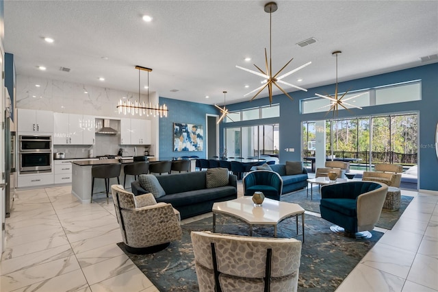 living room featuring a textured ceiling and an inviting chandelier