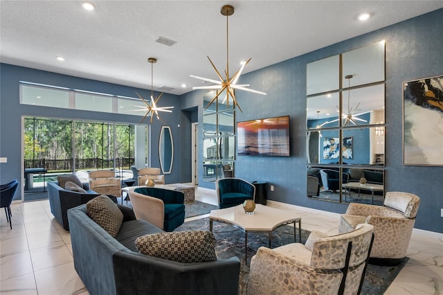 living room featuring a chandelier and a textured ceiling