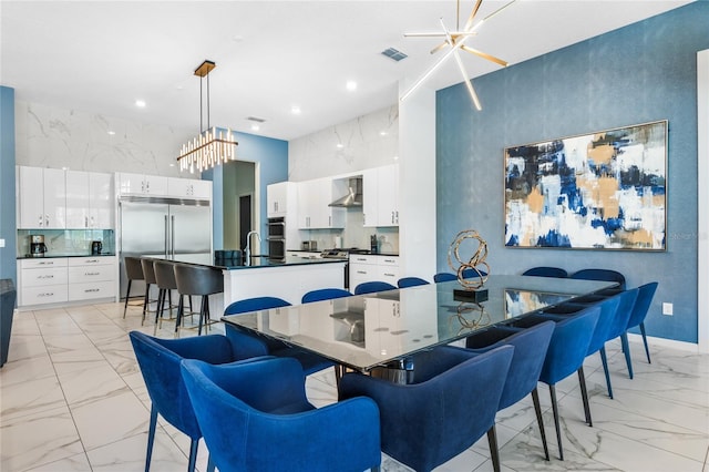 dining room with sink and an inviting chandelier