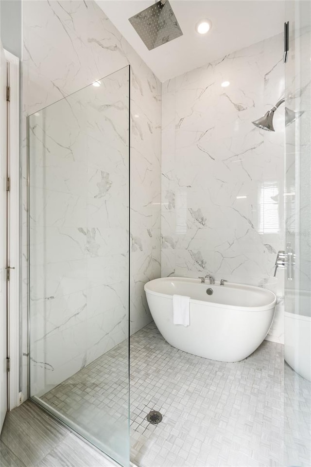 bathroom with independent shower and bath and tile walls