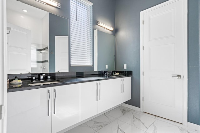 bathroom featuring vanity and a shower with door