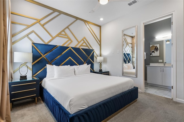 carpeted bedroom featuring ensuite bathroom and ceiling fan