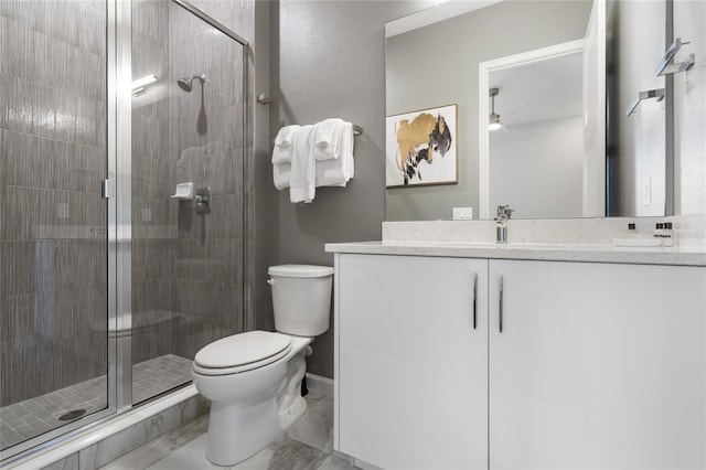 bathroom featuring vanity, toilet, and a shower with door