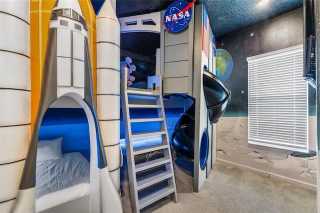 carpeted bedroom featuring a textured ceiling