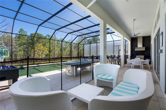 view of patio / terrace featuring ceiling fan and a lanai