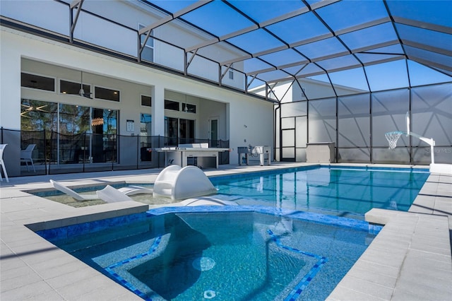 view of pool with an in ground hot tub, a patio, an outdoor bar, and a lanai