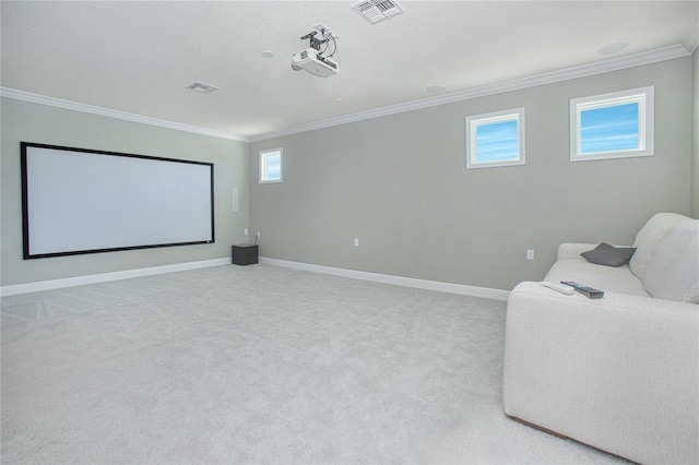 cinema featuring ornamental molding, a textured ceiling, a wealth of natural light, and light colored carpet