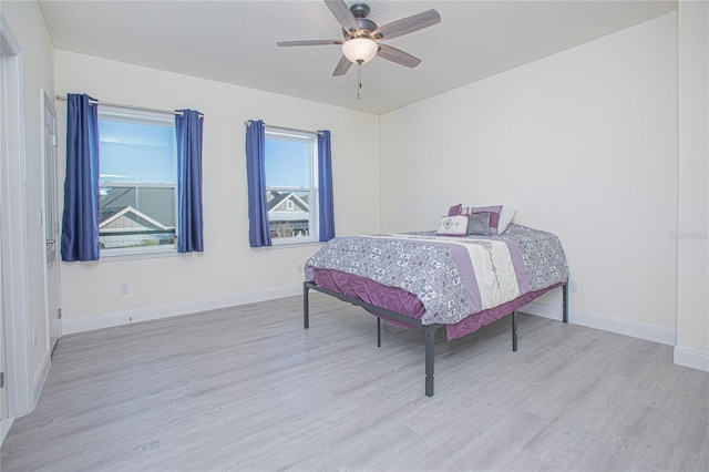 bedroom with ceiling fan and light wood-type flooring