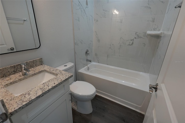 full bathroom with toilet, vanity, wood-type flooring, and tiled shower / bath