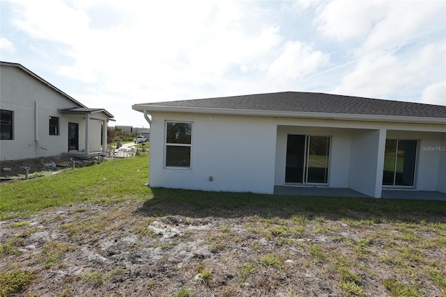 back of property featuring a yard