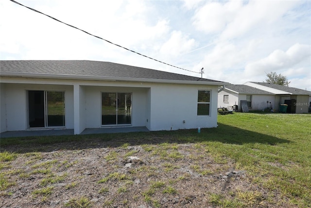 back of house with a lawn